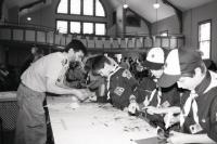 Cub Scouts line the “Pit Stop” to prepare their cars for the upcoming races.