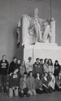 VUHS Travelers pause at the feet of Abraham Lincoln to reflect and look out over the city of Washington DC.