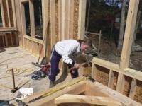 Armed with a hammer and patience, Sandy continues the pattern of many home builders, working full time during the day and going to the building site for long hours to work on the project.