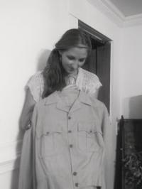 Carefully holding his uniform, granddaughter Erin Conner is one of many grandchildren who preserves not only the clothing and the stories, but continues on the family legacy of patriotism and belief in community service.