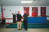 Bill LaBerge receives his Lions pin for 35 years of service from King Lion Roger Desabrais Jr.