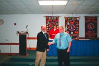 Greg Wry receives his Lions pin for 
30 Years of service from King Lion Roger Desabrais Jr.