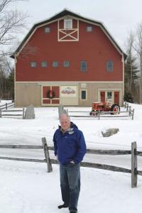 Sam Cutting IV stands in front of the new Dakin Farm production and office building in Ferrisburgh.