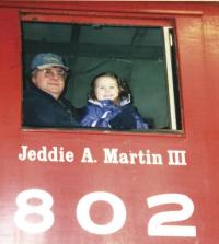 Chloe Martin thinks Poppa Martin Jed IV is pretty cool, when she gets to sit in the locomotive at the front of the huge train of cars at Vermont Railroad. 