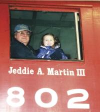 Chloe Martin thinks Poppa Martin Jed IV is pretty cool, when she gets to sit in the locomotive at the front of the huge train of cars at Vermont Railroad.