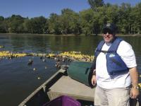 Michael Donnelly, Vergennes Rotarian puts the Rubber Ducks in Otter Creek for Saturday's Race.
