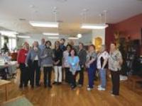 RCH Chair, Daphne Jensen, stands with Helen Porter staff holding the plaque dedicating the 3rd ARCH Room to the employees of HPHRC.