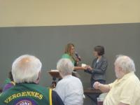 Joanne Corbett (right) receiving check from President Atkins.