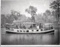 Sharing a Daniels family story takes the listener to a time in Addison County when the waterways were the main venues of transportation and a feisty and determined ancestor Philomene Daniels became America's first female licensed steamboat captain. Looking in the Pilot's House of the Daniels Steamboat the Little Nellie, Captain Phil is at the wheel dressed as always like a lady.