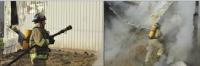 A firefighter continues to vent the still smoldering hay blaze with his pike pole about two hours after the initial assault, while another fireman stands by to cover him at hose point with a curtain of water if needed.