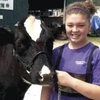 Bethany Orvis with a two year old milker at Addison County Field Days in 2014.