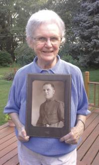 Donna Foley with a Picture of her Father Stephen J Reardon Sr in WWI Officer's uniform.