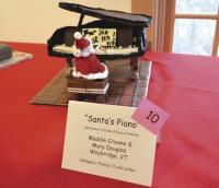 #10 “Santa's Piano” 
Santa can play and nibble at the same time as he enjoys a festive note at Vermont Folklife Center's 2015 exhibit. Created by: Maddie Crowne & Mary Douglas of Weybridge, Vt.
