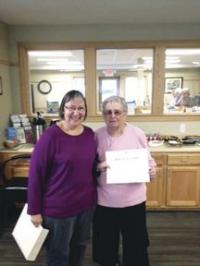DAR Regent Joy Minns awards Lois Huizenga-Higbee for her 40 years of membership and service in the local chapter of the Daughters of the American Revolution and her work at the local and state level.