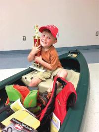 With a canoe full of prizes Axl Paquette's smile tells it all. Another generation is in love with the outdoors and fishing!

