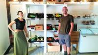 Jon and Mona Sullivan stand by some of the fresh produce available daily at their Vergennes store.