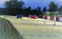 Brian Goodro driving a Pontiac Firebird and Gary Payne driving a Plymouth Superbird at the starting line at Devil's Bowl Speedway.