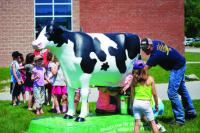 FFA students using Dairy Day to teach the next generation.