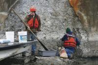    Construction crew members repair cement on lake Champlain Bridge Pier after erosion damage on key support piers prompted officials to close the bridge indefinitely last week. 