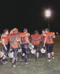 Jubilant mud-caked Tigers celebrate their over time win against Otter Valley 20-14 on a rain swept Friday night October 30, 2009 at Doc Collins Field. The Tigers will now face undefeated Colchester in a Divisional play off game this weekend. The winner moves on to the Division II State Championship a week later.