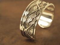 Sterling silver bracelet hand fabricated in the overlay technique by Josh Riney. 
